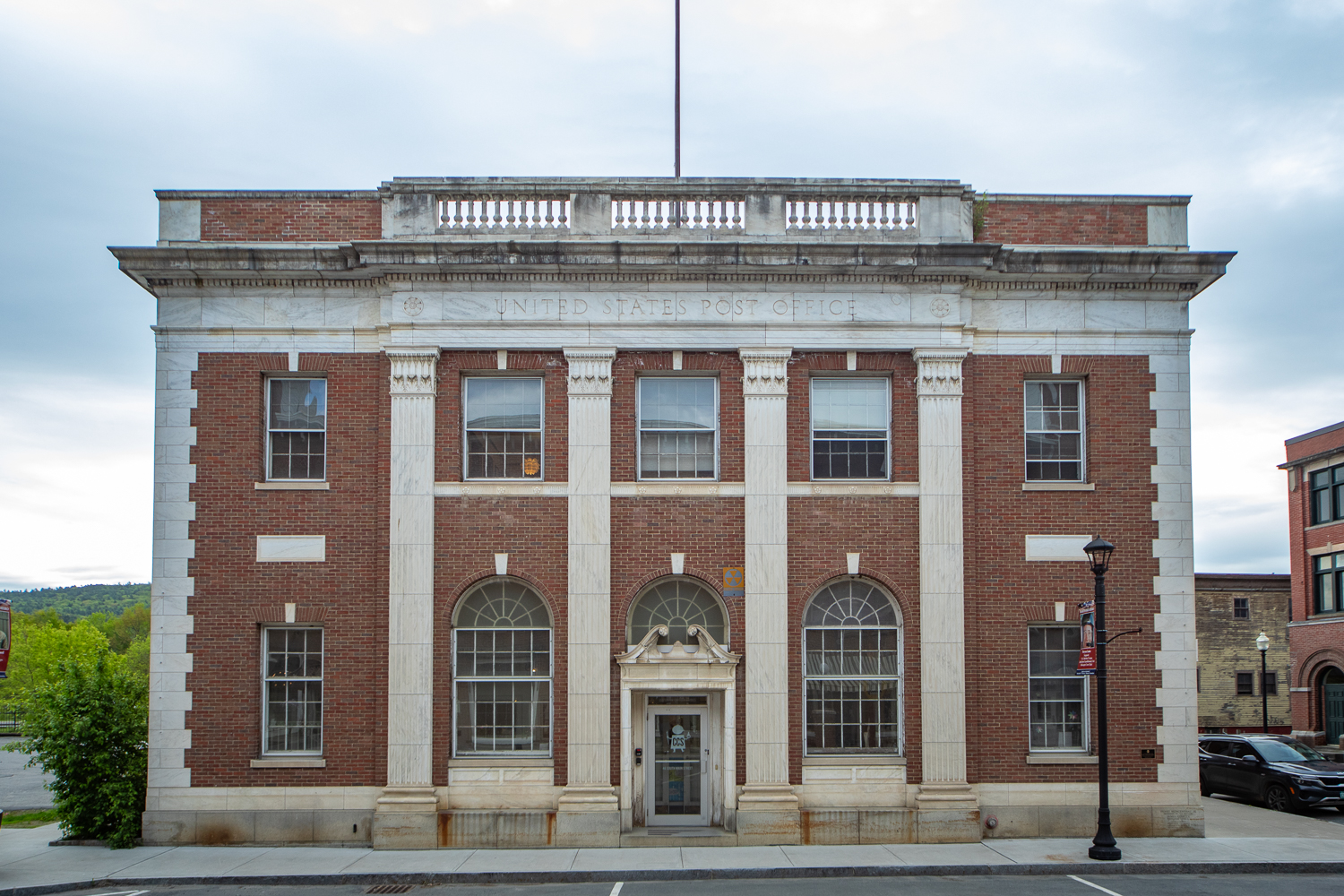 a large brick building with arched windows that says 'CCS' on the front door