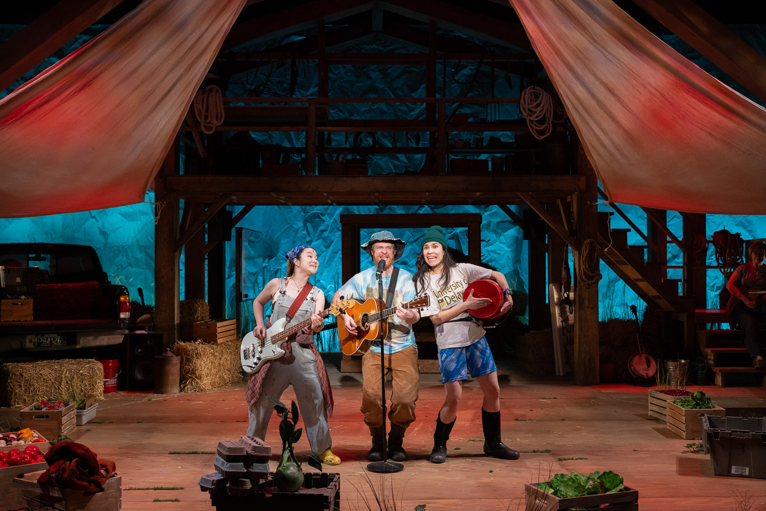 8. Angel Lin, Rob Morrison, and Raquel Chavez in THE VERMONT FARM PROJECT. Photo by Kata Sasvari Musicians performing on stage with guitars and drums at Norther Stage.